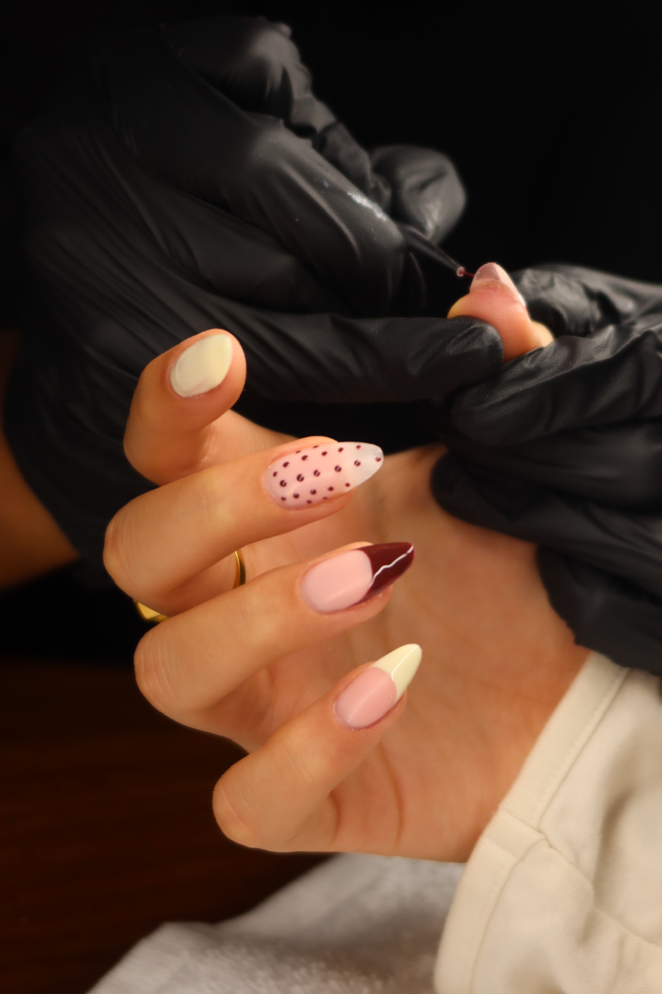 Mobile Maniküre mit rosa Nail Art und gepunktetem Design